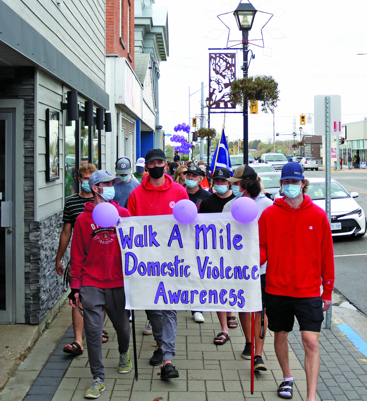 Residents gather to “walk a mile in her shoes”